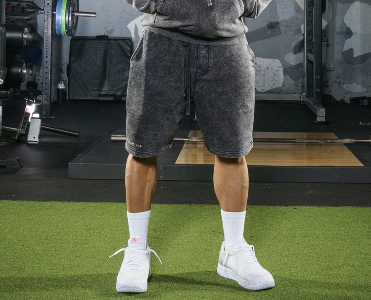 gray acid wash shorts with Elev8tion on the leg