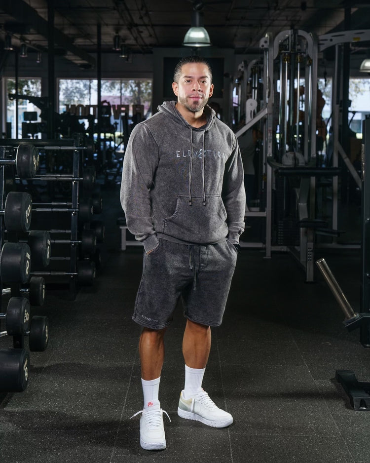 gray acid wash shorts and hoodie with Elev8tion across the chest